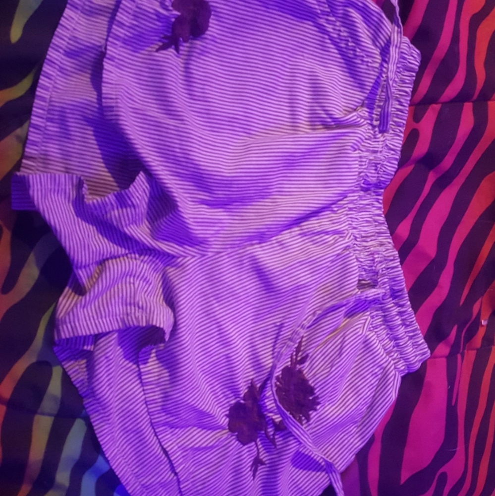 Purple striped shorts with a flower on them